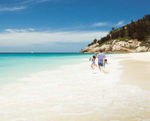 north-island-seychelles-resort-family-at-beach north-island-seychelles-resort-family-at-beach